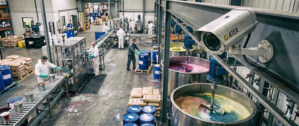 SWGJ stainless steel explosion-proof camera monitoring paint mixing vats and ink production lines in a solvent-based manufacturing facility.