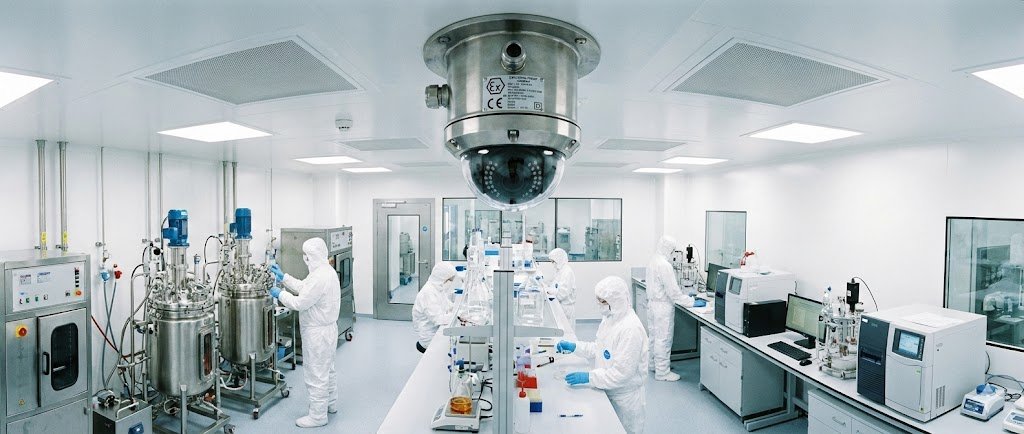 SWGJ stainless steel explosion-proof dome camera installed on the ceiling of a biopharmaceutical cleanroom laboratory for security and process monitoring.