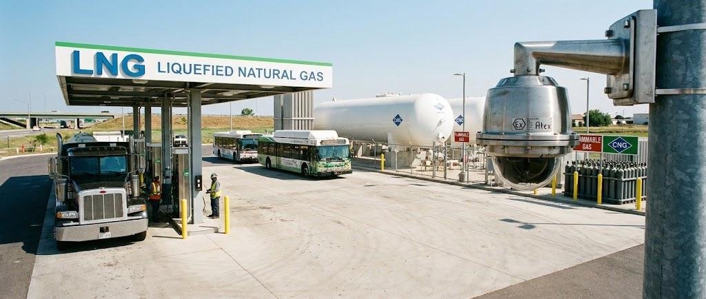 SWGJ stainless steel explosion-proof dome camera monitoring an LNG/CNG fueling station, storage tanks, and vehicle refueling operations.